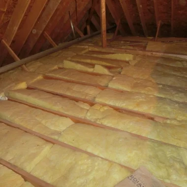 Fiberglass batt insulation installed between attic joists