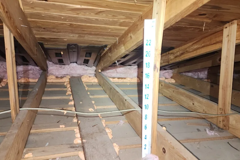 Air sealing work at attic top plates and penetrations in a Wake County NC home before blown-in insulation installation